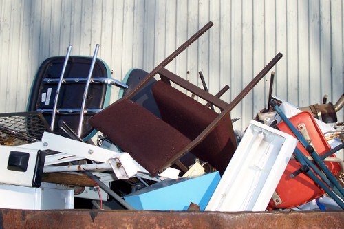 Cluttered garage before clearance in Brimsdown